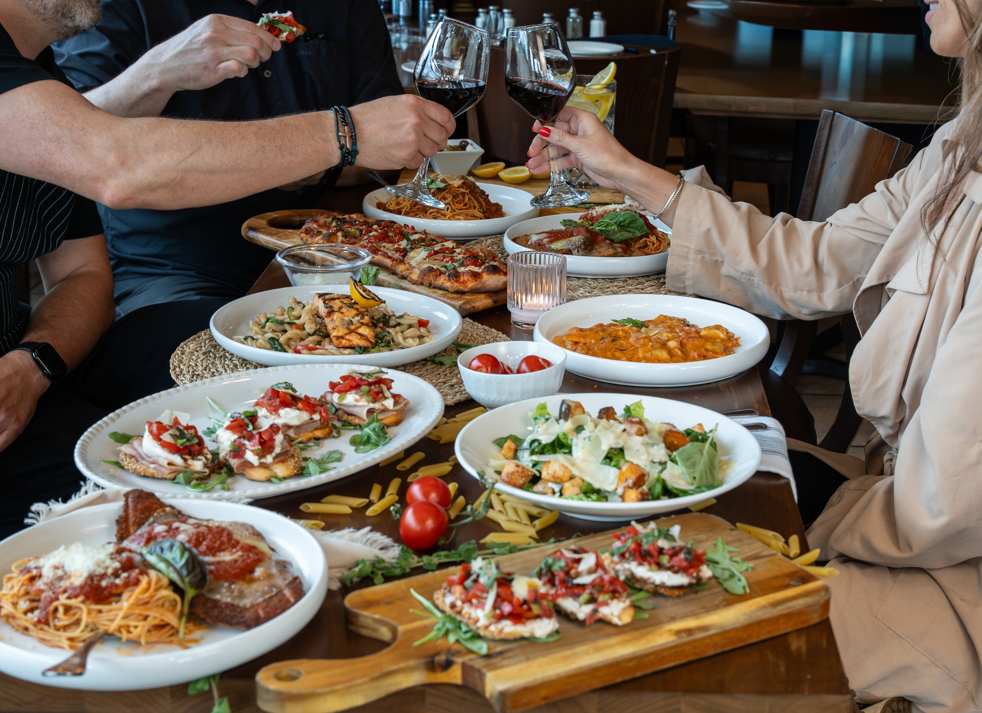 Table spread of pasta, pizza, salads, and wine at Piazza Presto, Limerick PA
